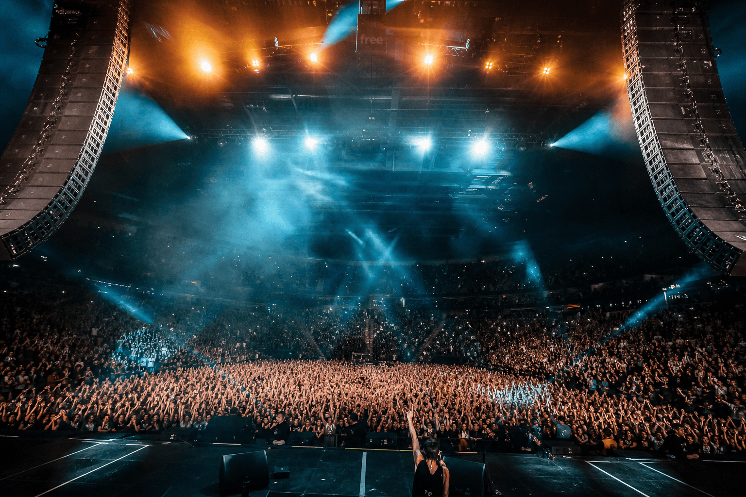 Concert crowd under dramatic stage lighting